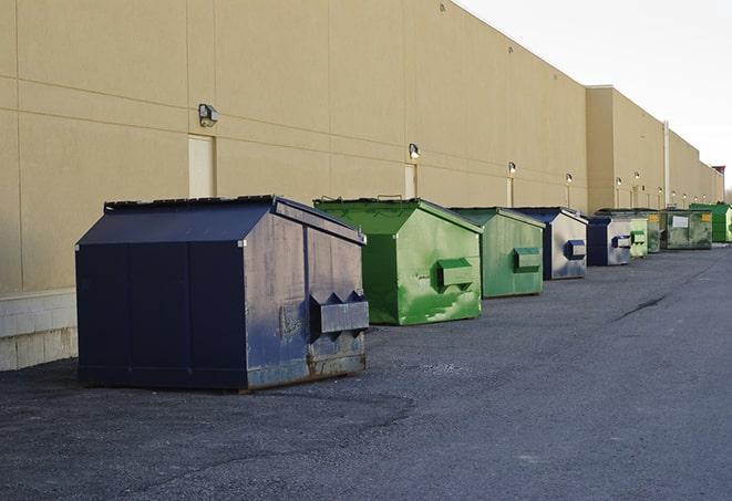 a collection of bright and vibrant dumpsters in a construction zone in Bluffdale